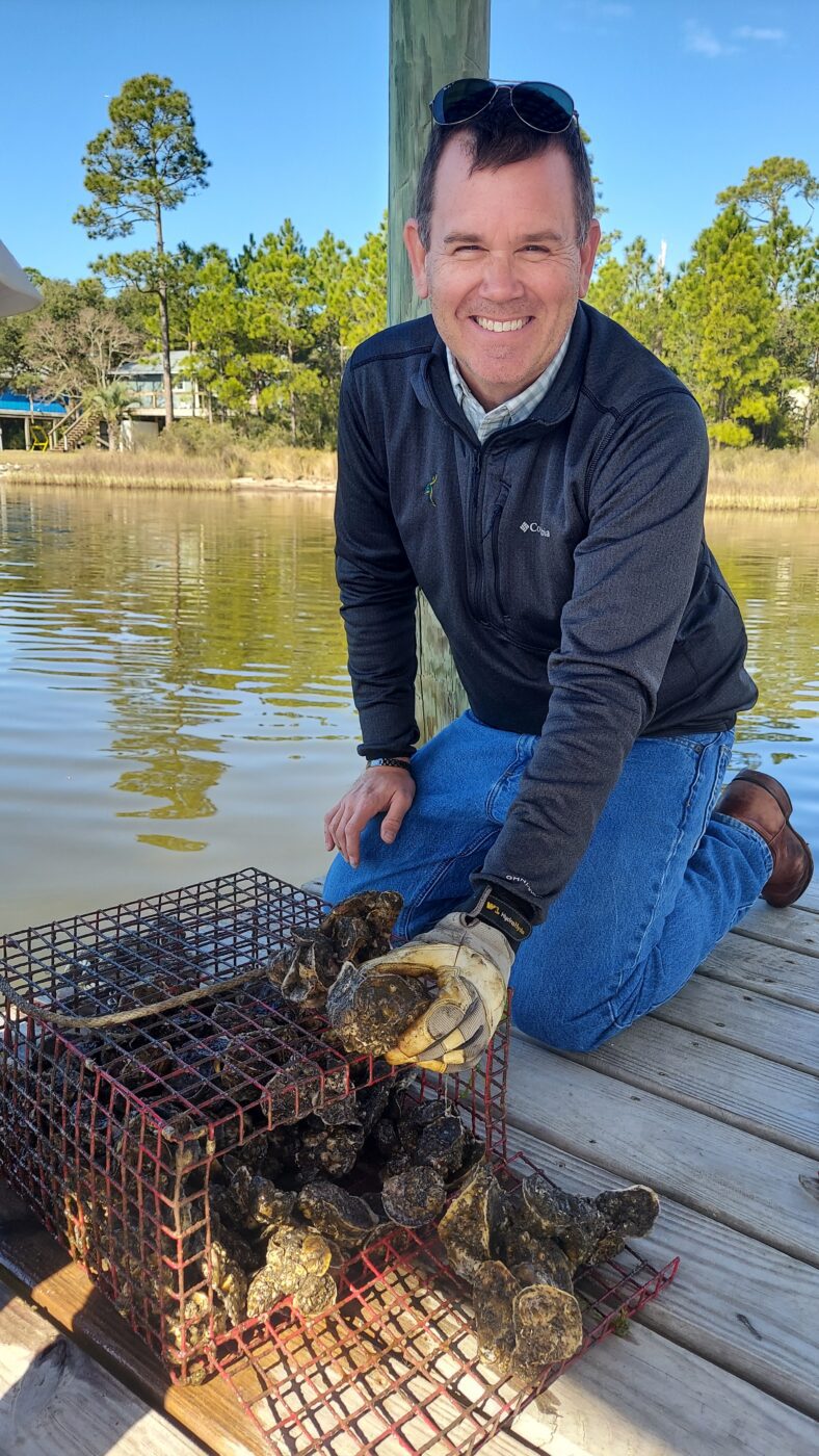 P.J. Waters shows oysters grown through the Extension oyster gardening program. Volunteers raise oysters on recycled shells before they are returned to coastal waters to help rebuild Alabama’s reefs.