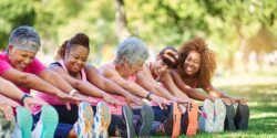 Women in park stretching for fitness.
