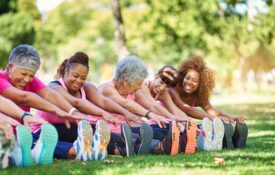 Women in park stretching for fitness.