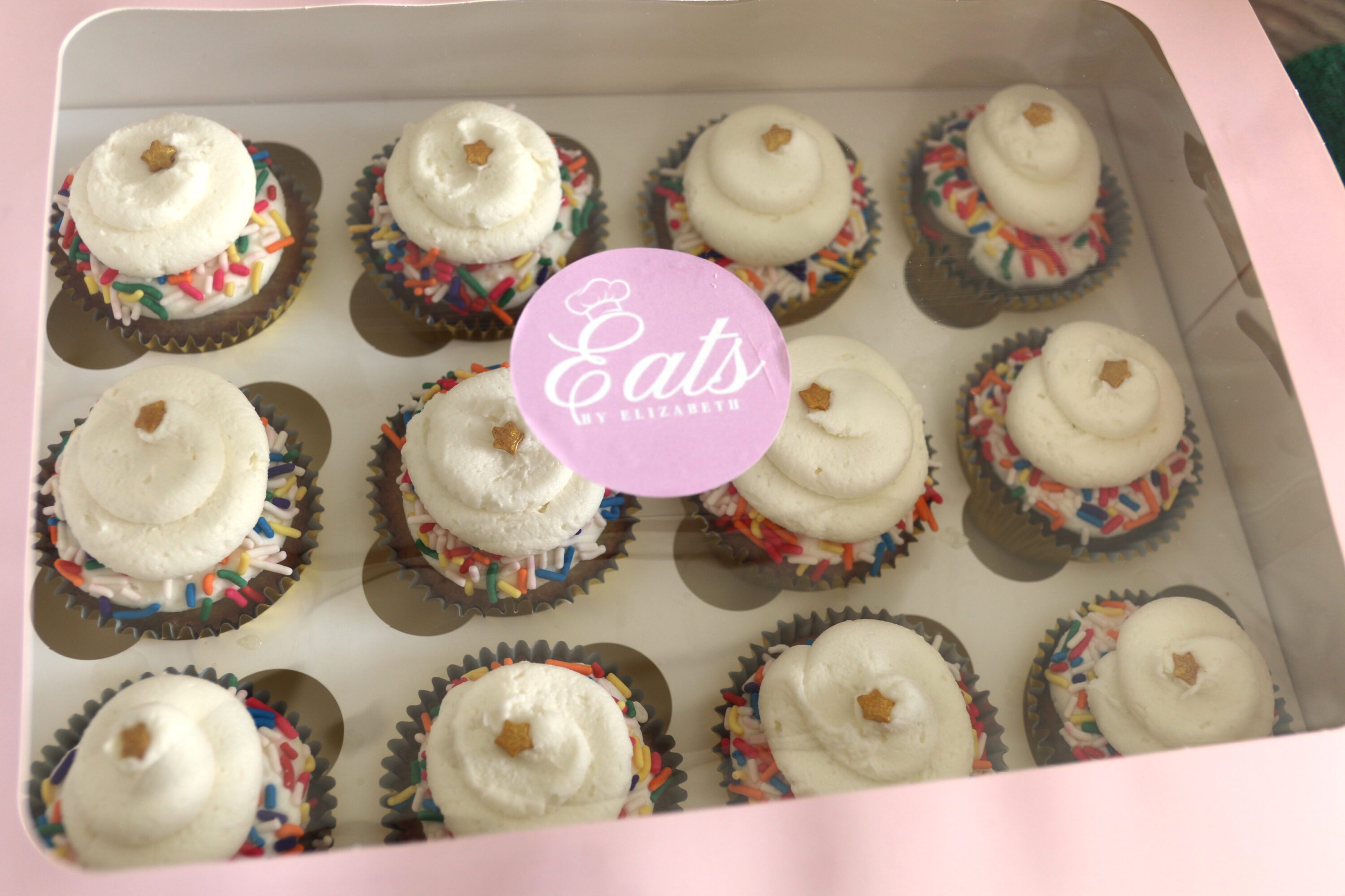 A box of cupcakes with an Eats by Elizabeth sticker.