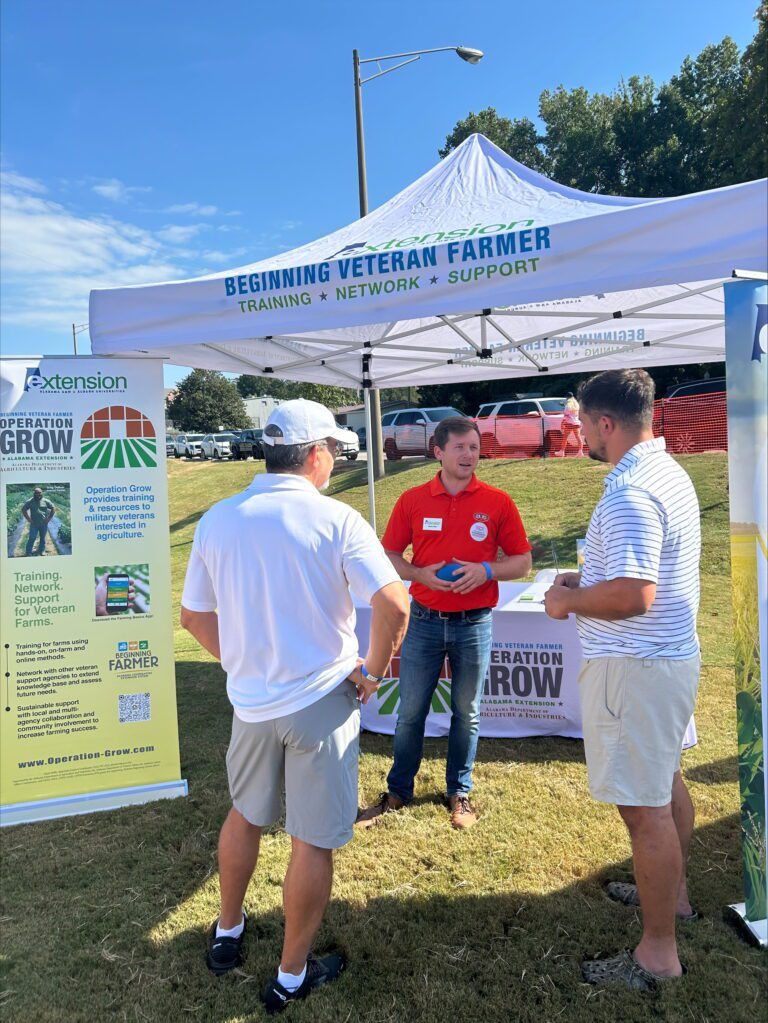 Figure 7. Jesse Teel discusses farming issues with individuals interested in Operation Grow.