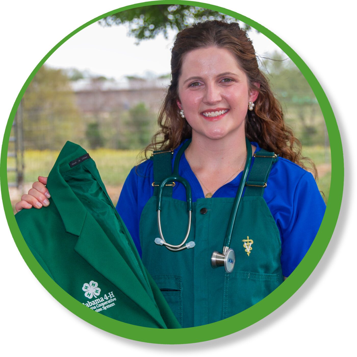 Kaleigh Backstrom posing for a photo with her 4-H state ambassador jacket.