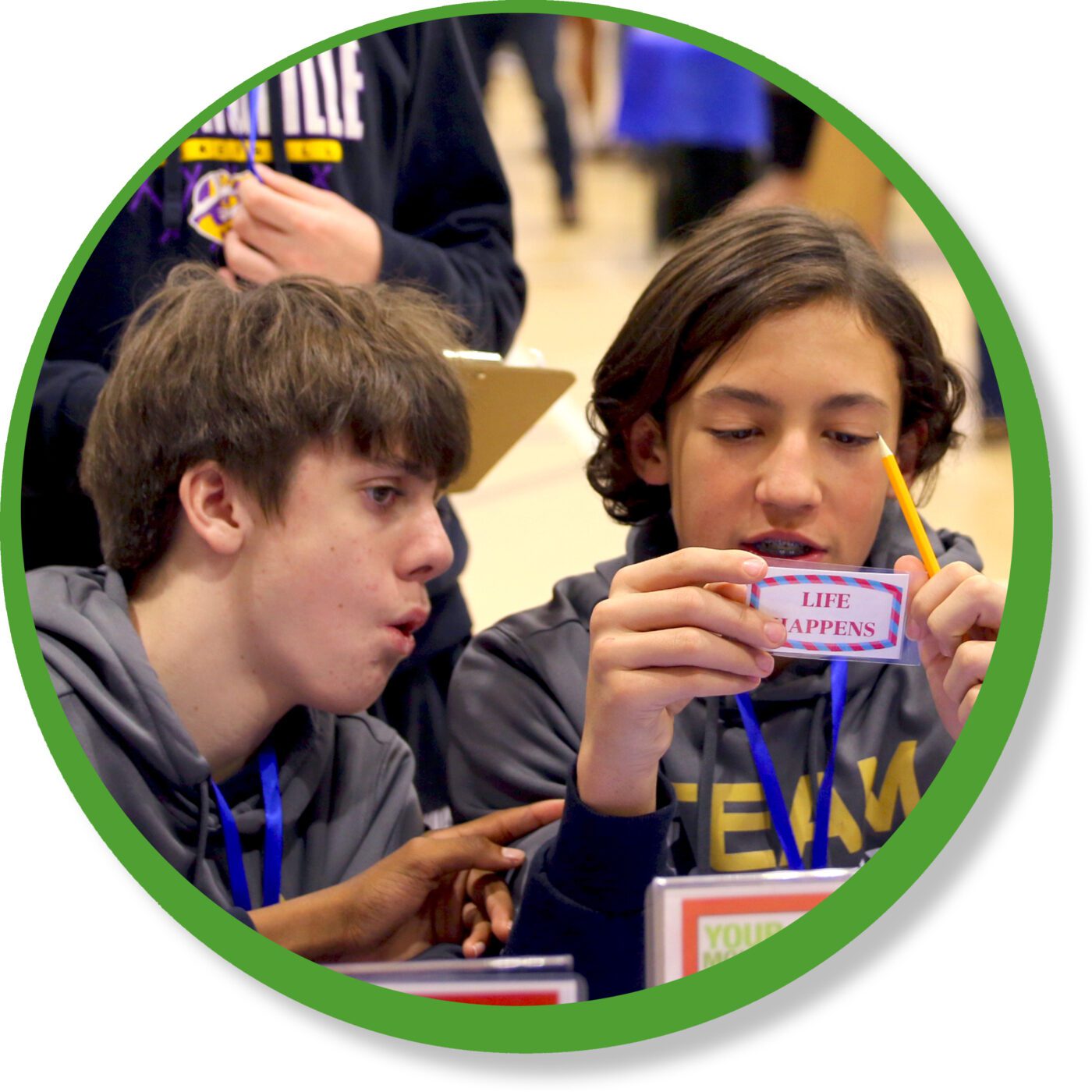 A photo of two St. Clair County students reacting to Life Happens card at the Your Money, Your Life program.
