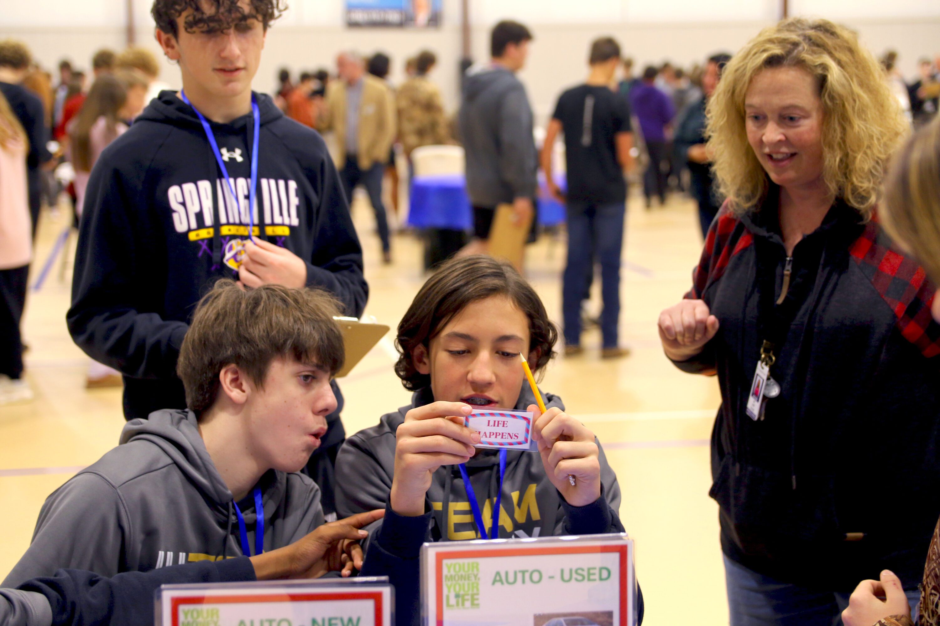 St. Clair County students reacting to Life Happens card at the Your Money, Your Life program.
