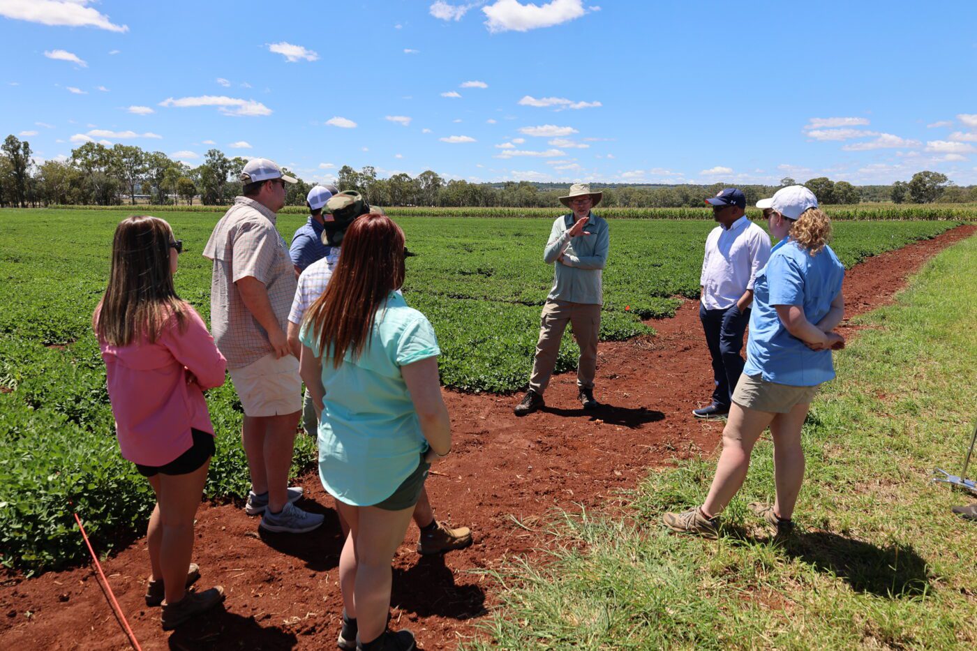 Auburn graduate students discuss growing Australian peanuts with breeder GraemeWright at the J. Bjelke-Petersen Research Facility in Kingaroy, Queensland.