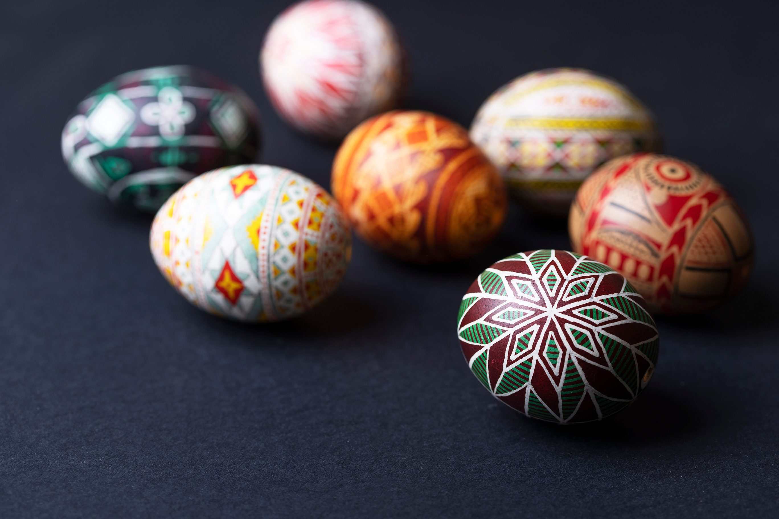 Pysanka Easter eggs on a black background.