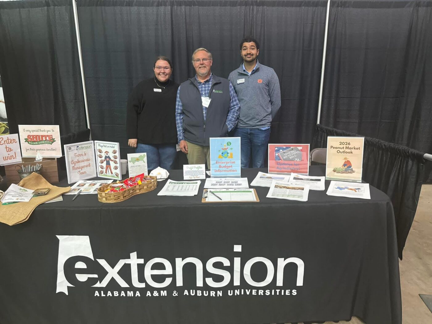 Figure 1. Calen Monroe, Extension agent, Ken Kelley, Extension agent, and Wendiam Sawadgo, Extension economist, discuss programs and answer questions as they represent Alabama Extension.