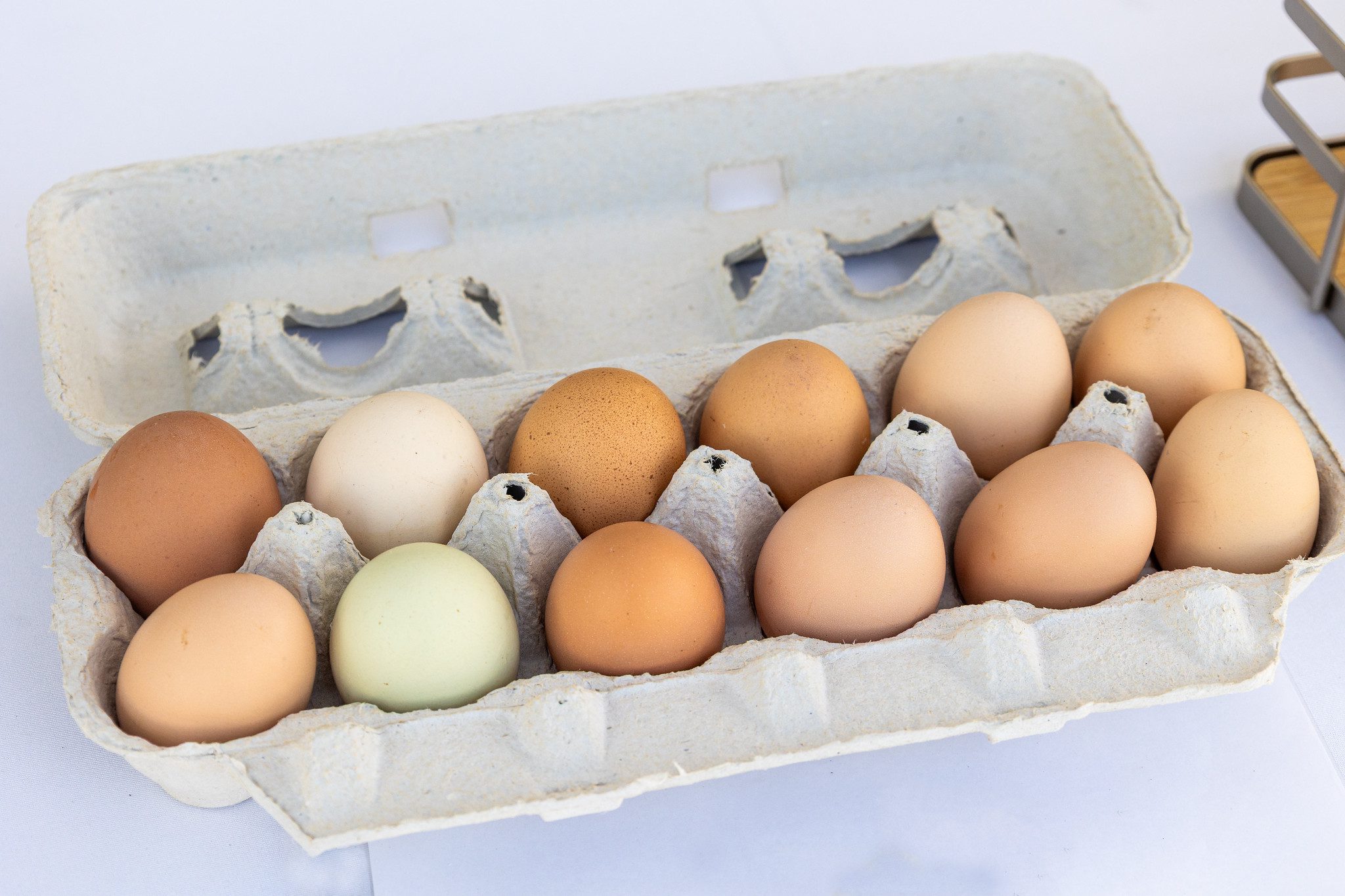 A carton of backyard eggs at a farmers market