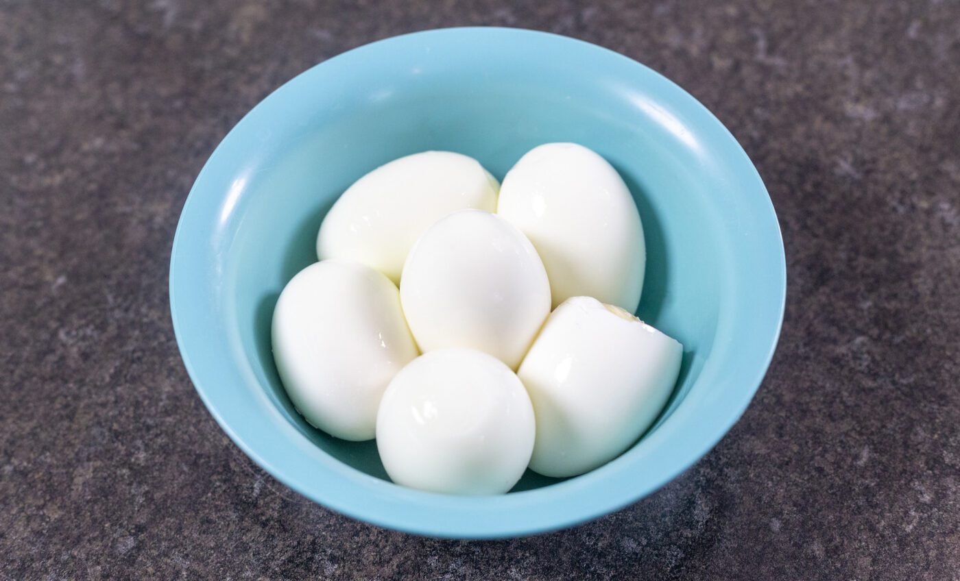 Boiled eggs in a blue bowl.