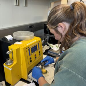 A 4-H member working in a lab to collect data related to poultry science.