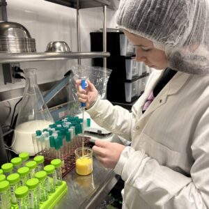 A 4-H member working in a lab to collect data related to poultry science.