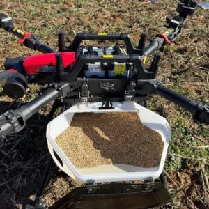 An agricultural drone with a tank containing cereal rye seed.