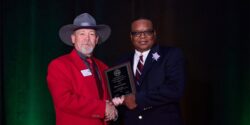 Marcus Garner receiving NACAA Distinguished Service Award from