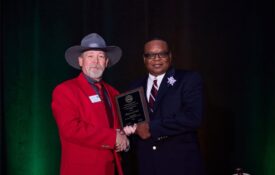 Marcus Garner receiving NACAA Distinguished Service Award from