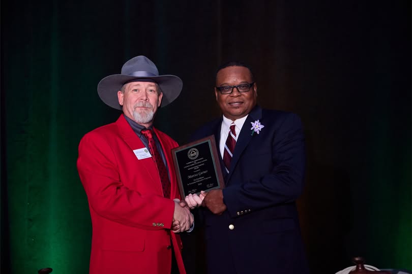 Marcus Garner receiving NACAA Distinguished Service Award from