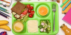 Serving tray of healthy food and stationery on white wooden table, flat lay. School lunch for farm to school