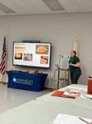 Figure 8. Brigid McCrea, Extension specialist, explains the use of pumpkin seeds for poultry at Pumpkins & Poultry in the Talladega County Extension office.