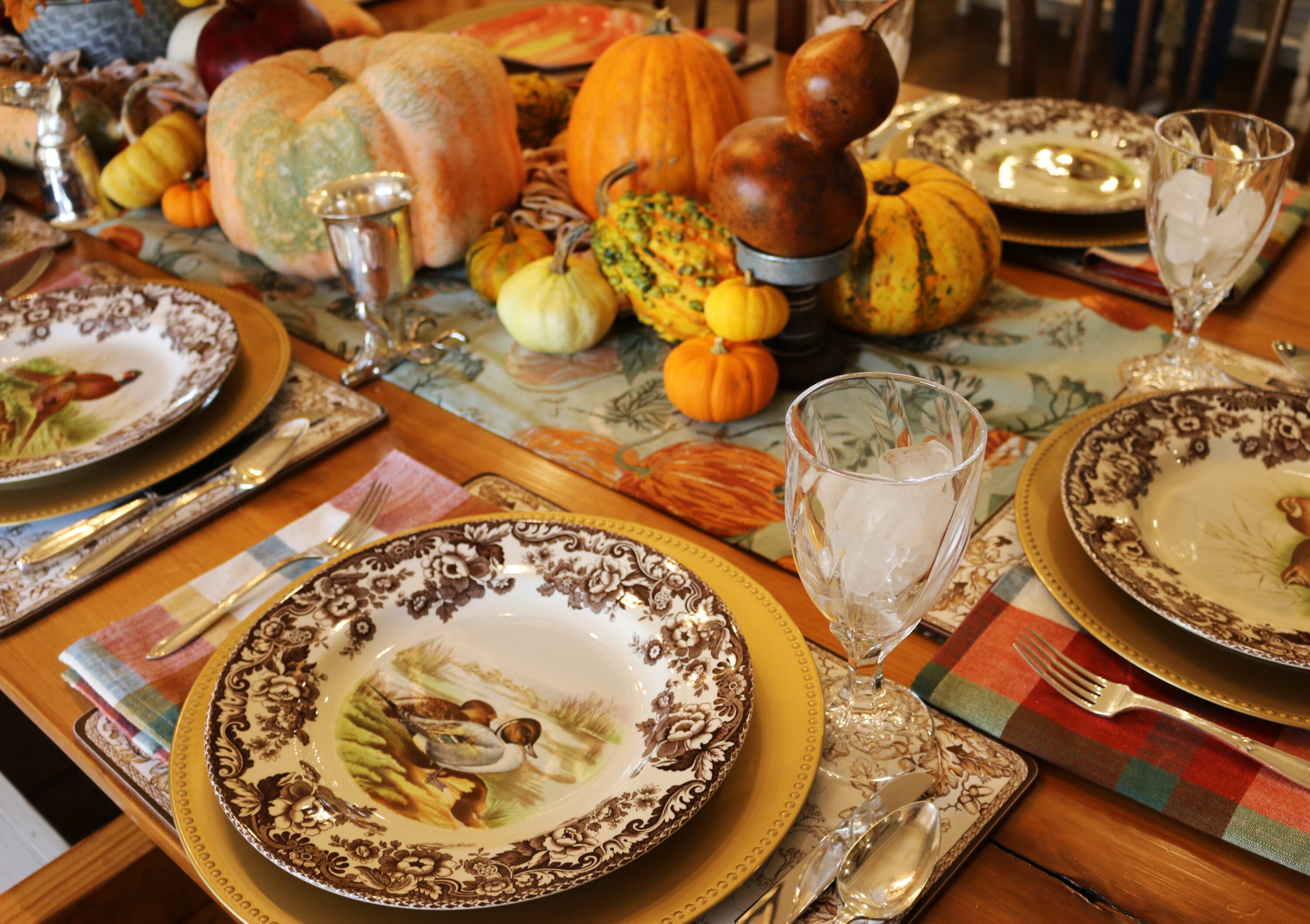 thanksgiving table setting with plates around a table